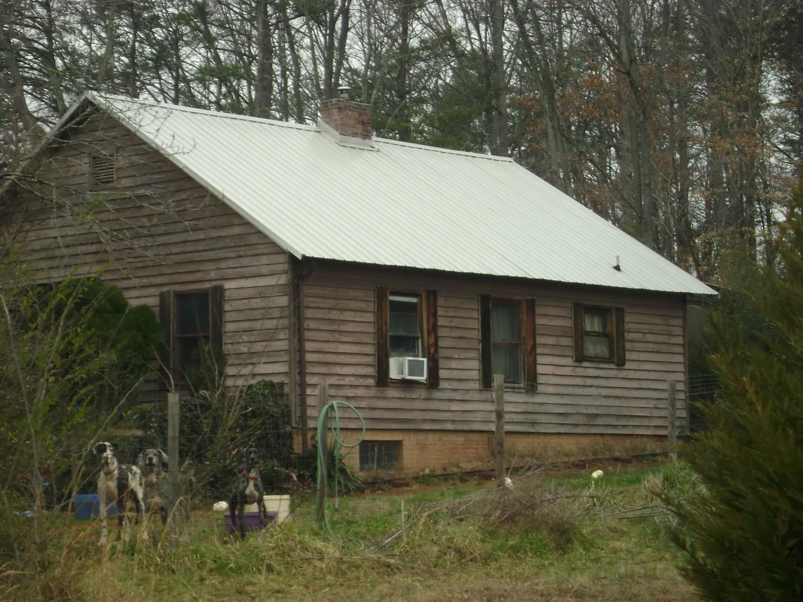 White metal roof on an old wood sided farmhouse, from a Metal Roof Installation job in Davidsville